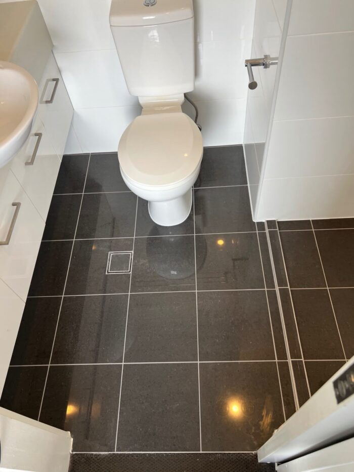 The same bathroom tiles after MRX regrouting, with crisp uniform grout lines